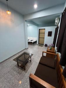 a living room with a couch and a table at Beach Side Home Stay - Kihim in Kīhīm +8 photos