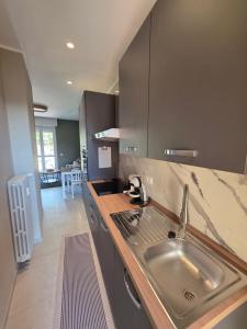 a kitchen with a sink and a counter top at Canelli Wine Suites - Moscato & Barbera in Canelli +31 photos