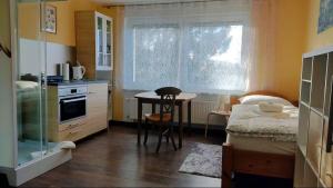 a small kitchen with a table and a bed in a room at Up'N'Down - Rooms in Nuremberg