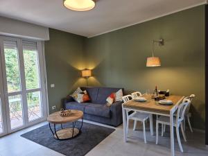 a living room with a blue couch and a table at Canelli Wine Suites - Moscato & Barbera in Canelli