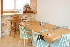 a kitchen with a wooden table and chairs at Mulberry House by the Sea Νέα Μάκρη in Nea Makri