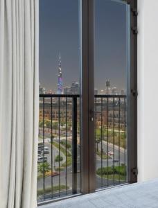 a room with a window with a view of a city at Ultimate Stay Port de La Mer with Burj Khalifa Views from the Bed next to the Beach in Dubai