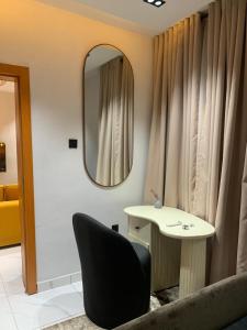 a room with a mirror and a table and a chair at 1Bdrm, 24hrs light, security personnel in Surulere