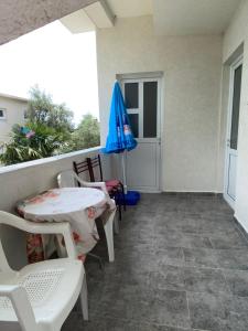 a patio with an umbrella and a table and chairs at Milun Stan in Sutomore
