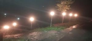 a row of lights on a road at night at Thulasitharayil in Vagamon +4 photos