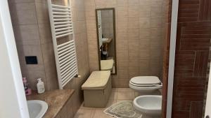 a bathroom with a toilet and a sink and a mirror at il campanile in Gaeta