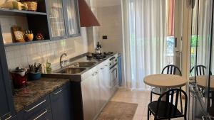 a kitchen with a sink and a table in it at il campanile in Gaeta