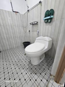 a bathroom with a toilet in a shower stall at Erigeron homestay dieng in Banjarnegara +22 photos