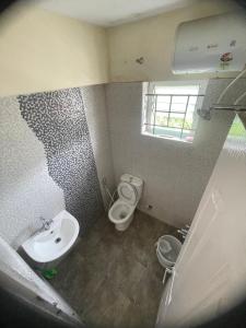 a small bathroom with a toilet and a sink at Angel Hollidays ooty in Ooty