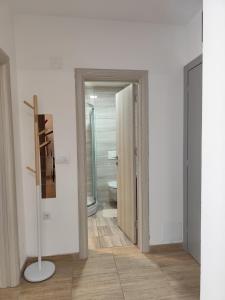 a bathroom with a door open to a toilet at Bili 3 in Paraćin +16 photos
