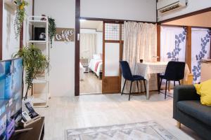 a living room with a couch and a table at DK Matsunaga House in Fukuyama