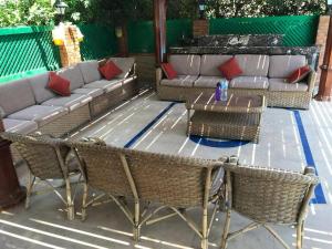 a patio with a couch and chairs and a table at Yousef chalet in Amman