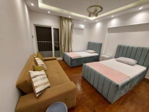 a living room with two beds and a couch at Yousef chalet in Amman