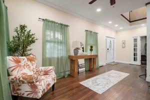 a living room with a chair and a table at Family Oasis Pool Firepit Creek Near Delaware in Cahoonzie