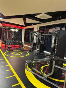 a gym with several treadmills and machines at Ubays Majestic House in Kuala Lumpur