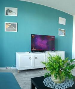 a living room with a television on a white entertainment center at Wild lakes home in Burgas City