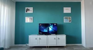 a tv sitting on top of a white cabinet in a room at Wild lakes home in Burgas City
