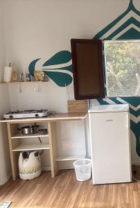 a small kitchen with a desk and a refrigerator at The Good Vibes Home in Hoya de Pineda +4 photos