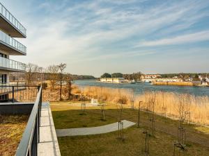 a view of the river from the balcony of a building at Navy Blue Dream - SPA - Basen - Parking in Dziwnów