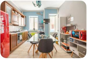 a kitchen with a glass table and chairs in it at Confortable in Trapani