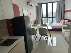 a kitchen and living room with a table and a bed at Ubays Majestic House in Kuala Lumpur
