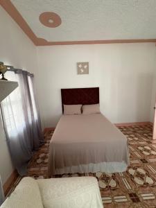 a bedroom with a bed and a couch at Blissful Oasis by Castle Adora in Tower Isle +26 photos