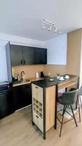 a kitchen with a counter and a table and chairs at Apartman Kladovo in Kladovo
