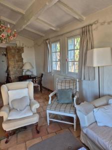 a living room with two chairs and a couch at La Ruchanne in Tourrettes-sur-Loup