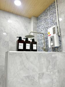 three bottles on a shelf in a bathroom at Montara villa Chaloklum Koh phangan in Chaloklum +16 photos