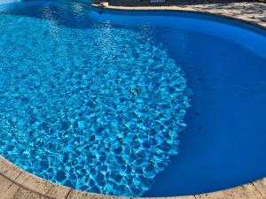 a blue swimming pool with blue water in it at La Ruchanne in Tourrettes-sur-Loup