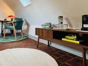a room with a table with a toy car on it at La Ferme de Montreuil in Montreuil-lʼArgillé