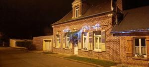 a brick building with a lot of lights on it at Côté Poules in Quesnoy-sur-Airaines