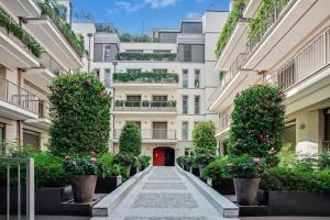 a courtyard of a building with plants and flowers at Townhouse in the heart of the city in Milan