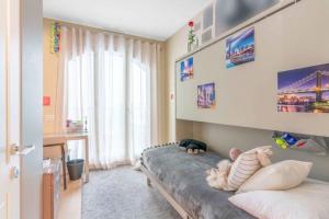 a baby laying on a bed in a bedroom at Townhouse in the heart of the city in Milan
