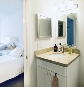 a bathroom with a sink and a bed at Beachside Modern Wellness at Jupiter Bay Resort in Jupiter