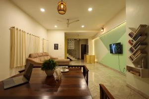 a living room with a table and a couch at Rostel Backpackers Hostel in Pune