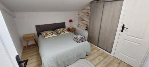 a small bedroom with a bed with pillows on it at L'Atelier in Perpignan
