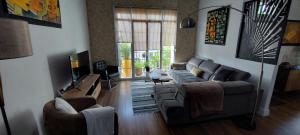 a living room with two couches and a television at L'Atelier in Perpignan