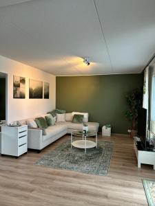 a living room with a couch and a table at Tranquil Apartment in Vantaa in Vantaa