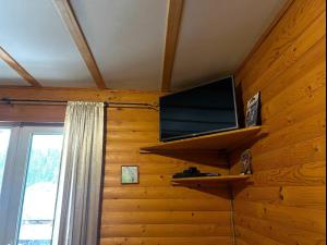 a flat screen tv on a wall in a room at Готель Могул in Vorokhta