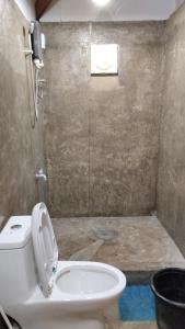 a bathroom with a white toilet and a sink at Lutaw Farm Pool and Villas in General Luna +18 photos