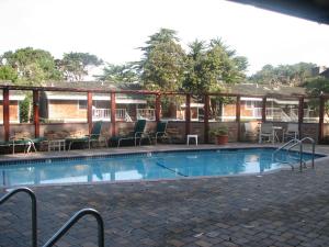 a swimming pool with a pool table in front of it at Lighthouse Lodge & Cottages in Pacific Grove