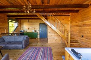 ein Wohnzimmer mit einer Couch und einer Treppe in der Unterkunft Via Bungalows Batumi in Batumi
