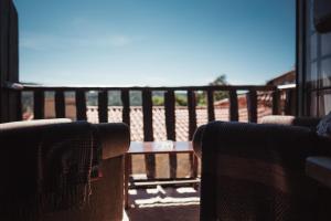 a view of the beach from a porch with two chairs at Casa dos Candeias - Apartamento Tio João in Chaves