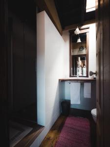 a bathroom with a toilet and a window at Casa dos Candeias - Apartamento Tio João in Chaves