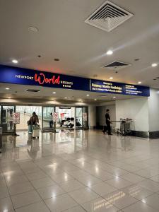 a lobby of an airport with people walking around at Kai cabins NAIA 3 walking distance Newport City Pasay in Manila