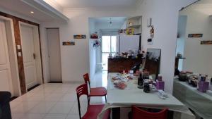 a kitchen with a table and chairs in a room at Apartamento da Mara in Belém