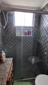 a bathroom with a shower with a glass door at Apartamento da Mara in Belém