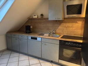 a kitchen with a sink and a stove and a sink at Schöne Maisonette-Wohnung in ruhiger Lage in Oer-Erkenschwick