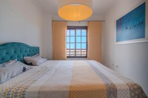 a bedroom with a large bed and a large window at Appartment Zomero, SEAVIEW & WIFI & POOL in Costa Del Silencio